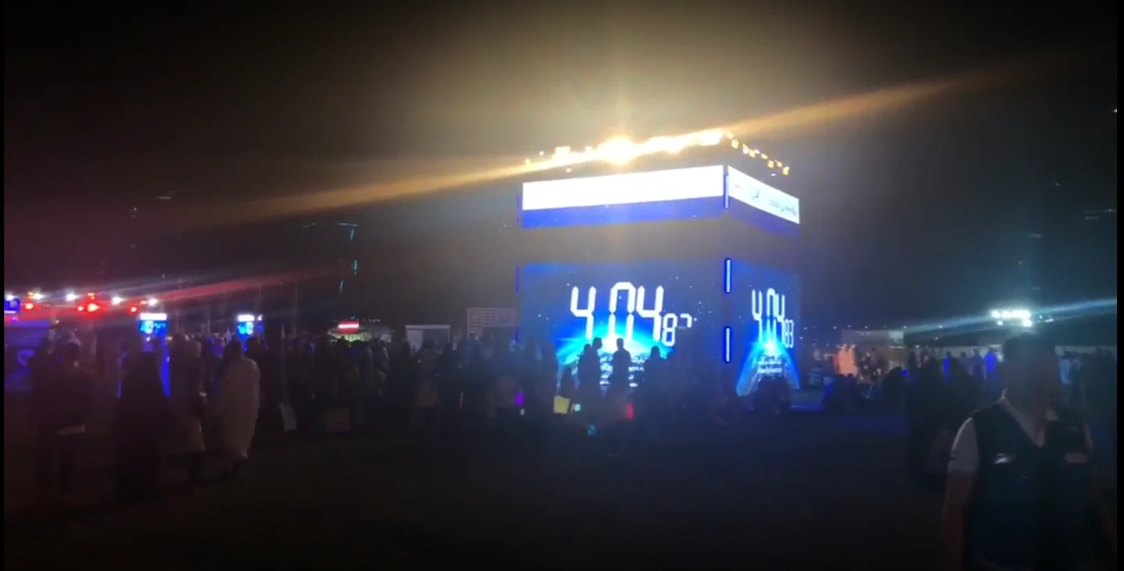 Attendees interacting with iPads to make environmental pledges displayed on a large LED screen with a 3D Earth model.