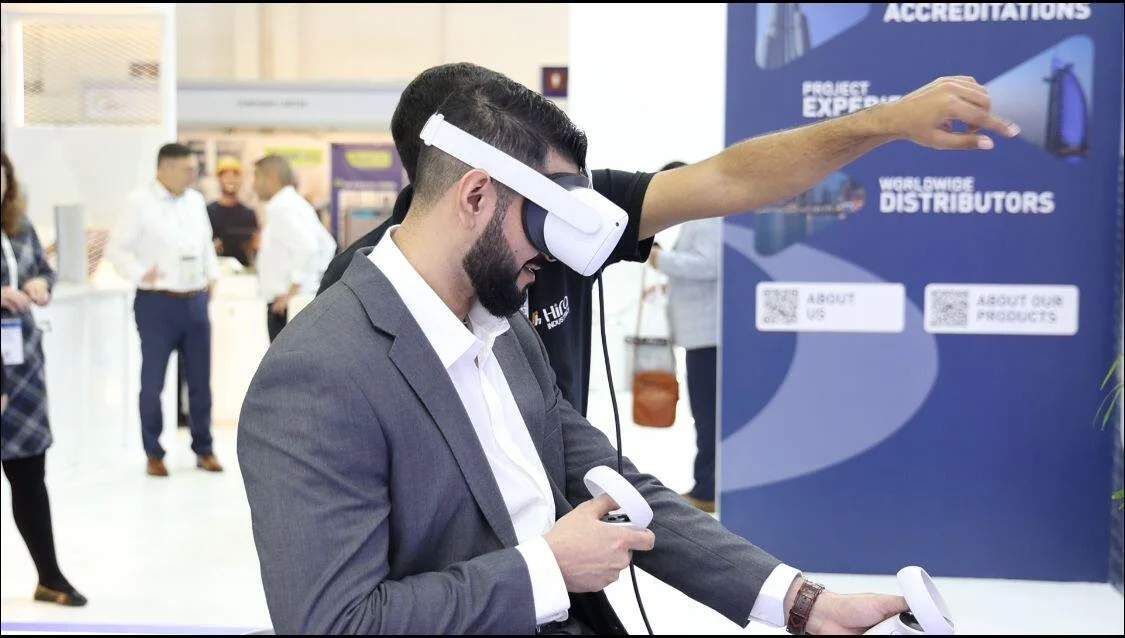 Person interacting with Hira Industries' VR product showcase in a virtual construction site.