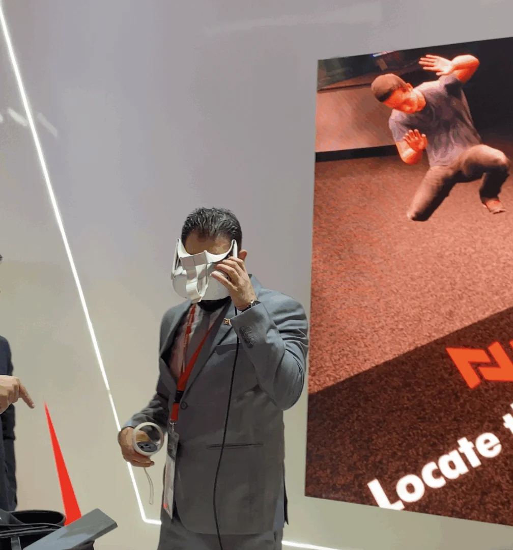 User experiencing NAFFCO's VR smoke management simulation in an office environment.