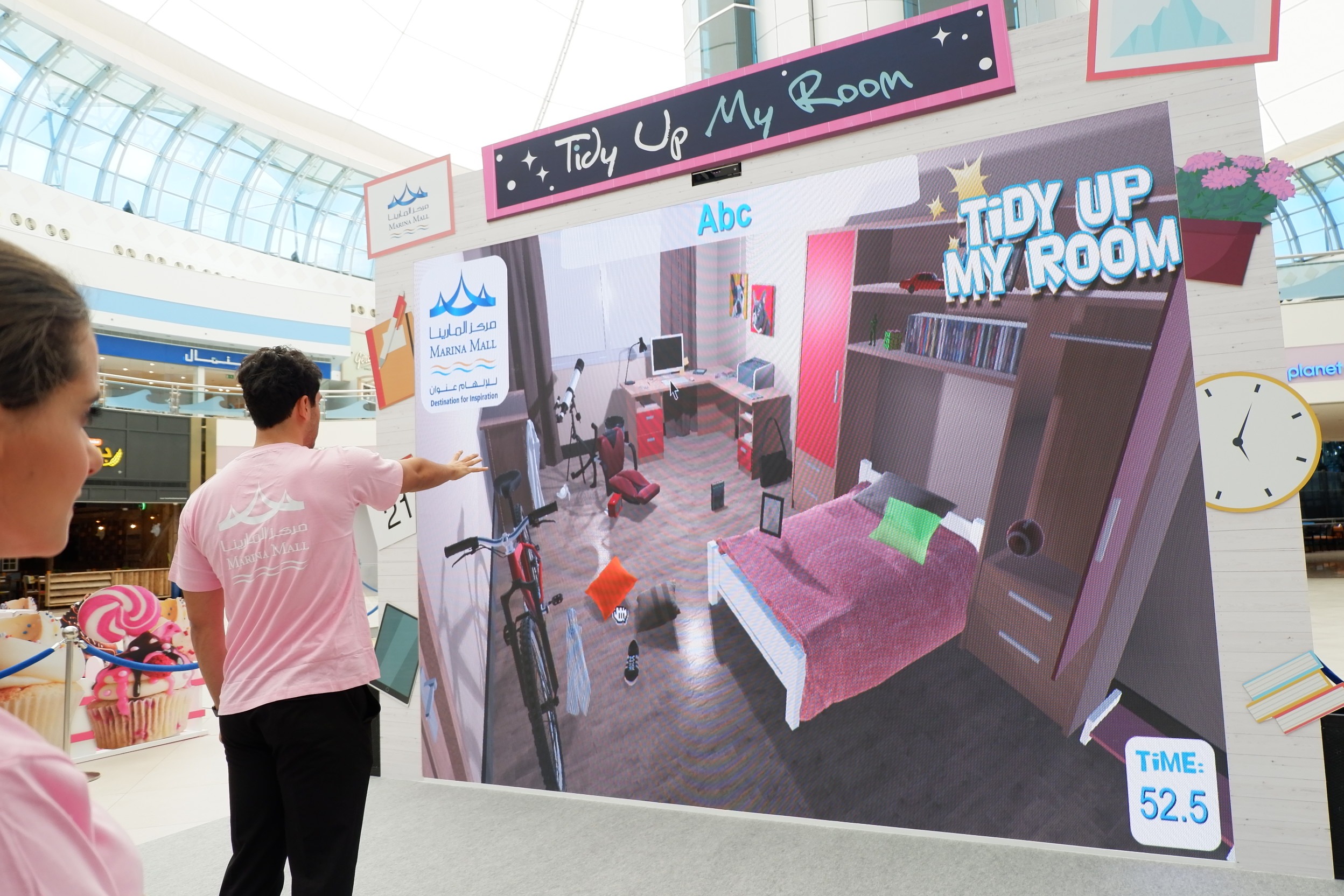 Children playing the Tidy Up My Room gesture game at Marina Mall Abu Dhabi.