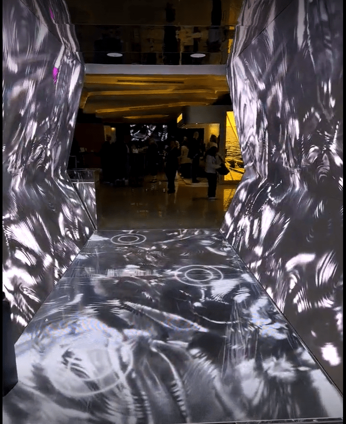 Interactive immersive tunnel for Chalhoub Group event featuring floor sensors and LED projection.