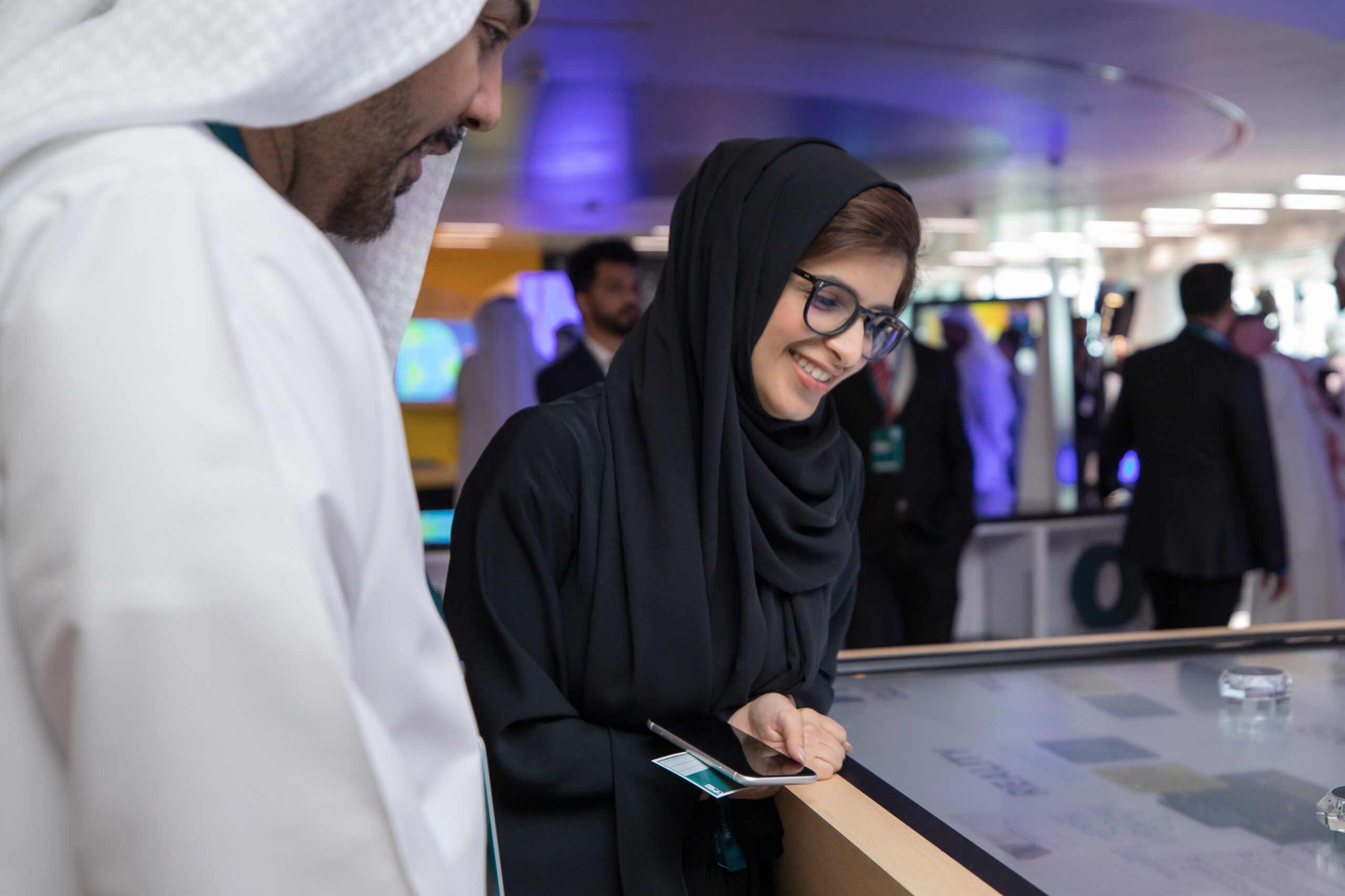 ADNOC interactive object recognition table by PearlQuest showing glass pucks on a 65-inch touch screen.