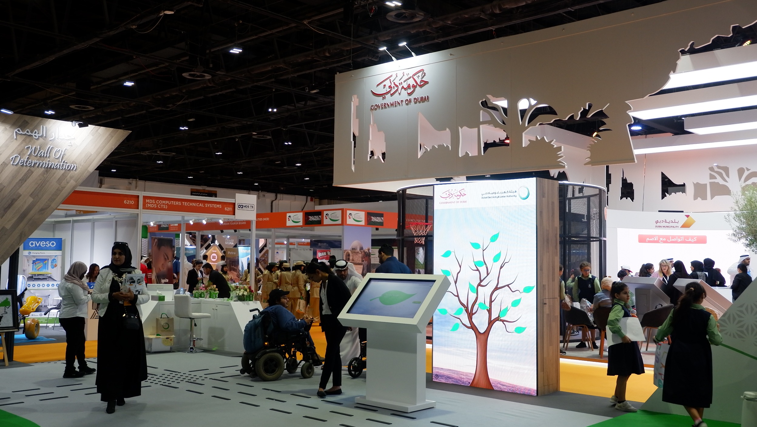 Interactive touchscreen wall showing animated leaf messages for DEWA brand activation.