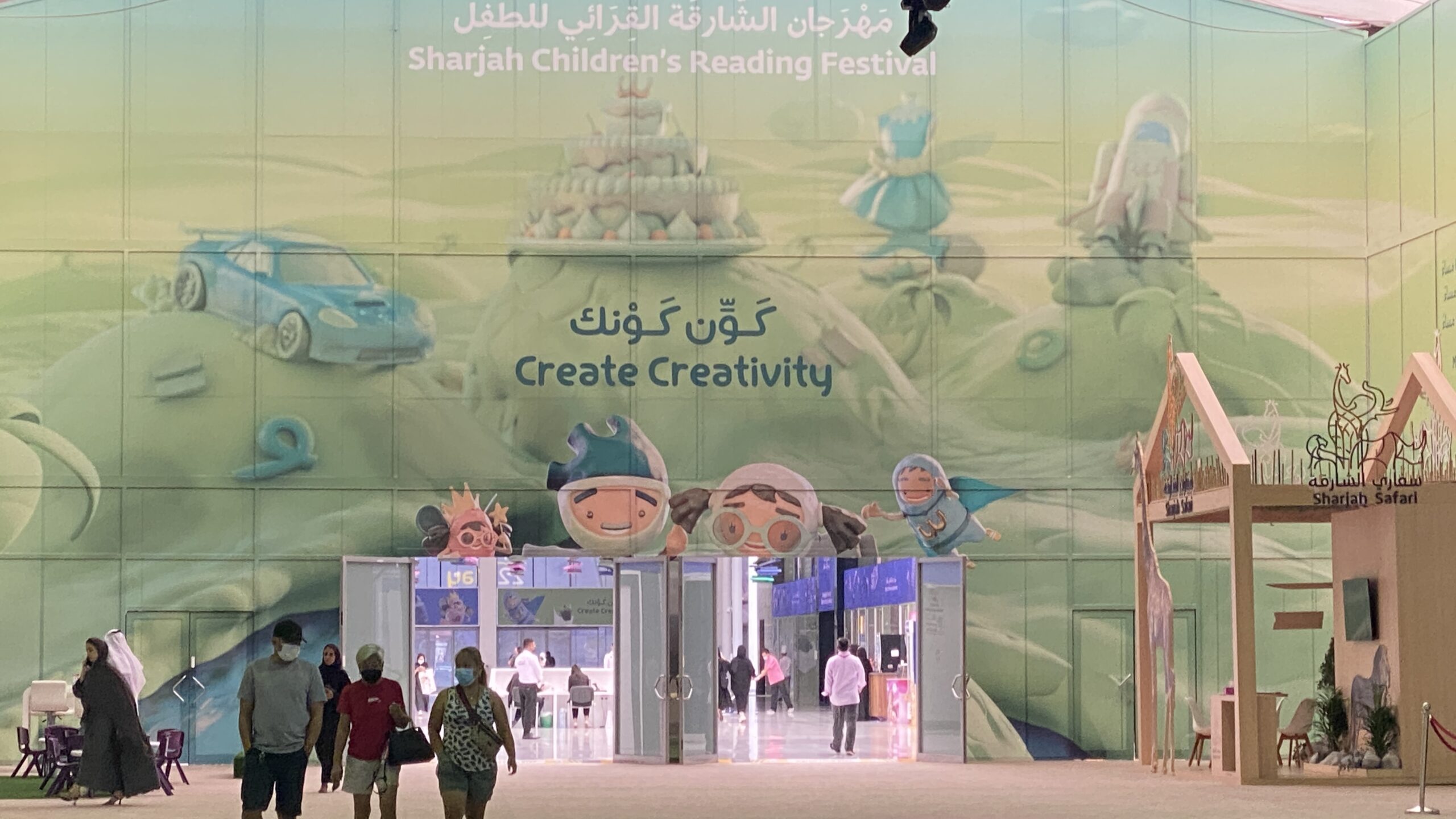 Children interacting with a conductive paint touch wall at Sharjah Children’s Reading Festival.