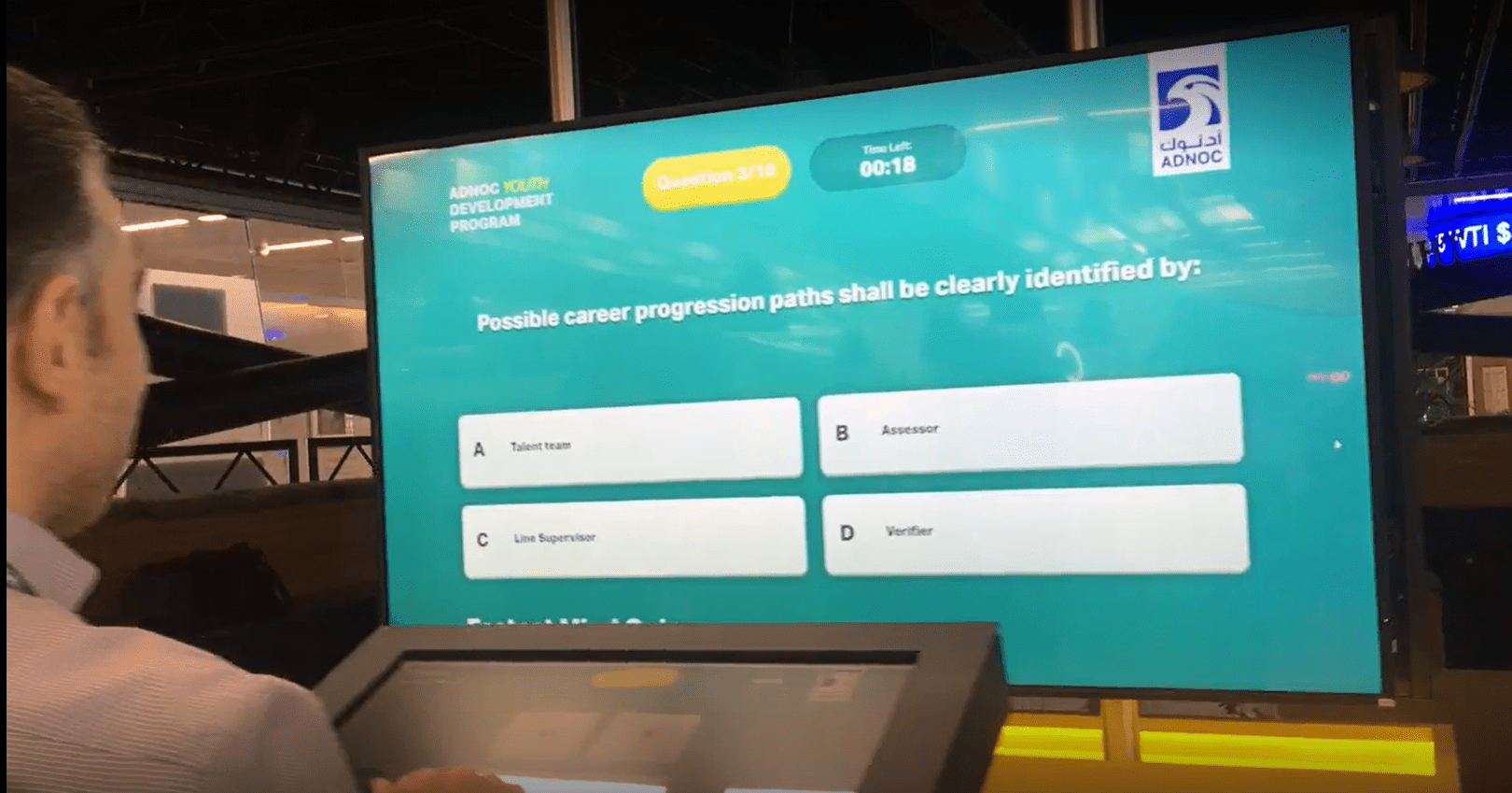 Four players competing in a real-time interactive quiz for ADNOC Youth Development Program.