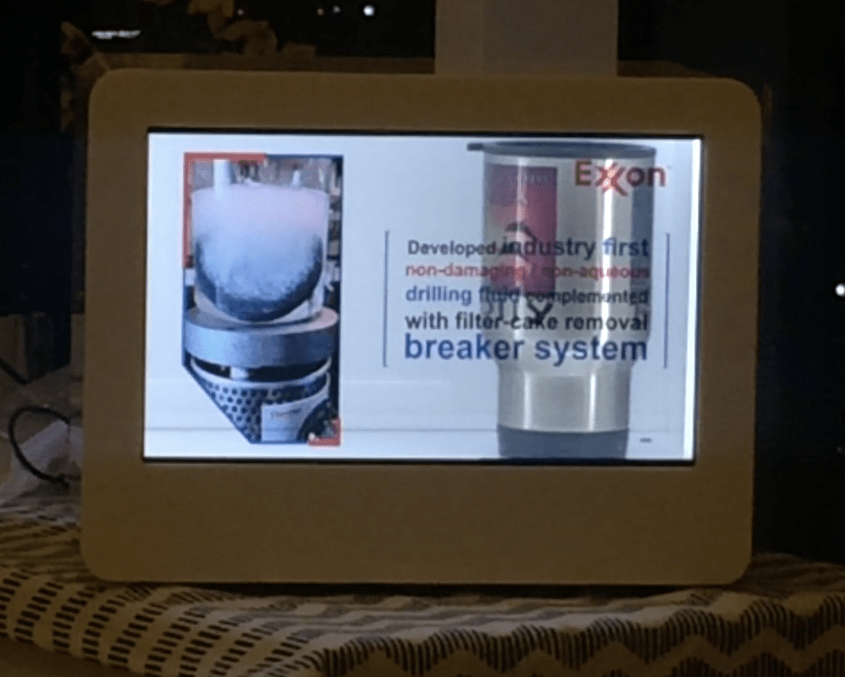 ExxonMobil interactive transparent kiosk showcasing digital product content.