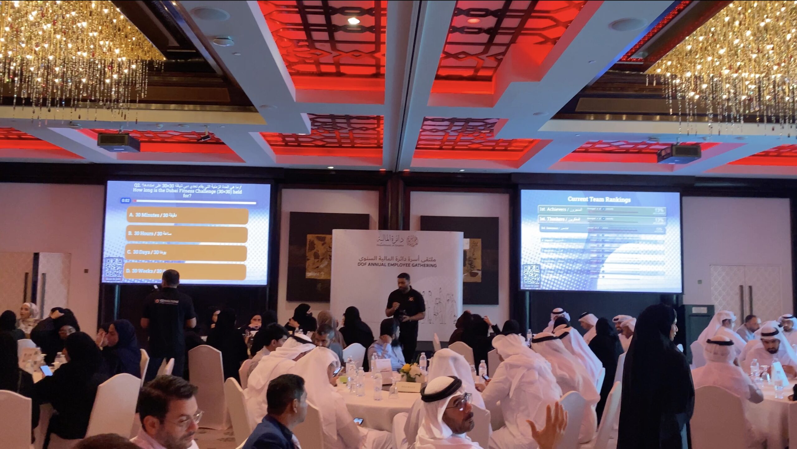 Attendees participating in a live event trivia quiz on their mobile phones.