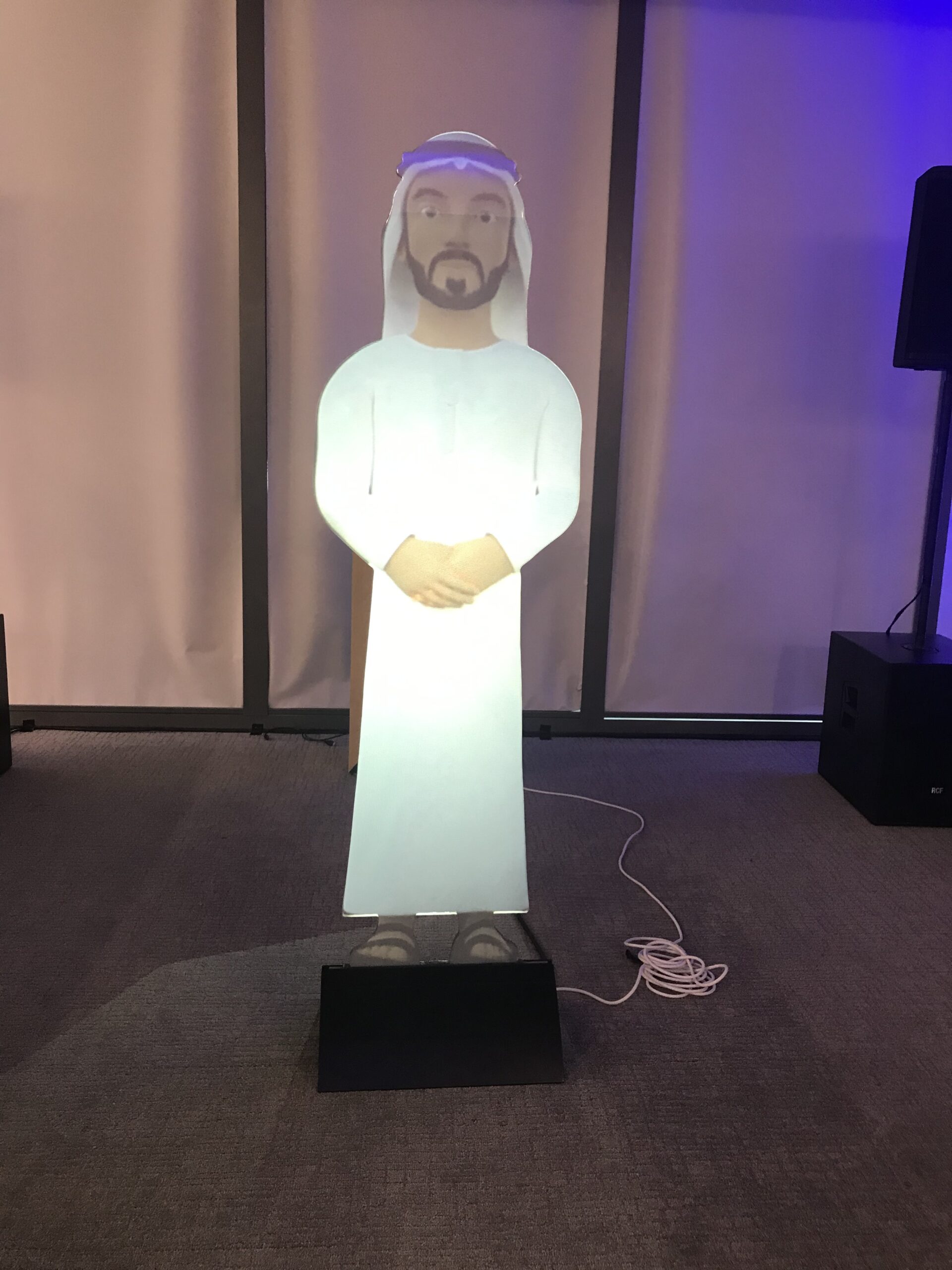 Visitor interacting with a digital avatar mascot at an event activation