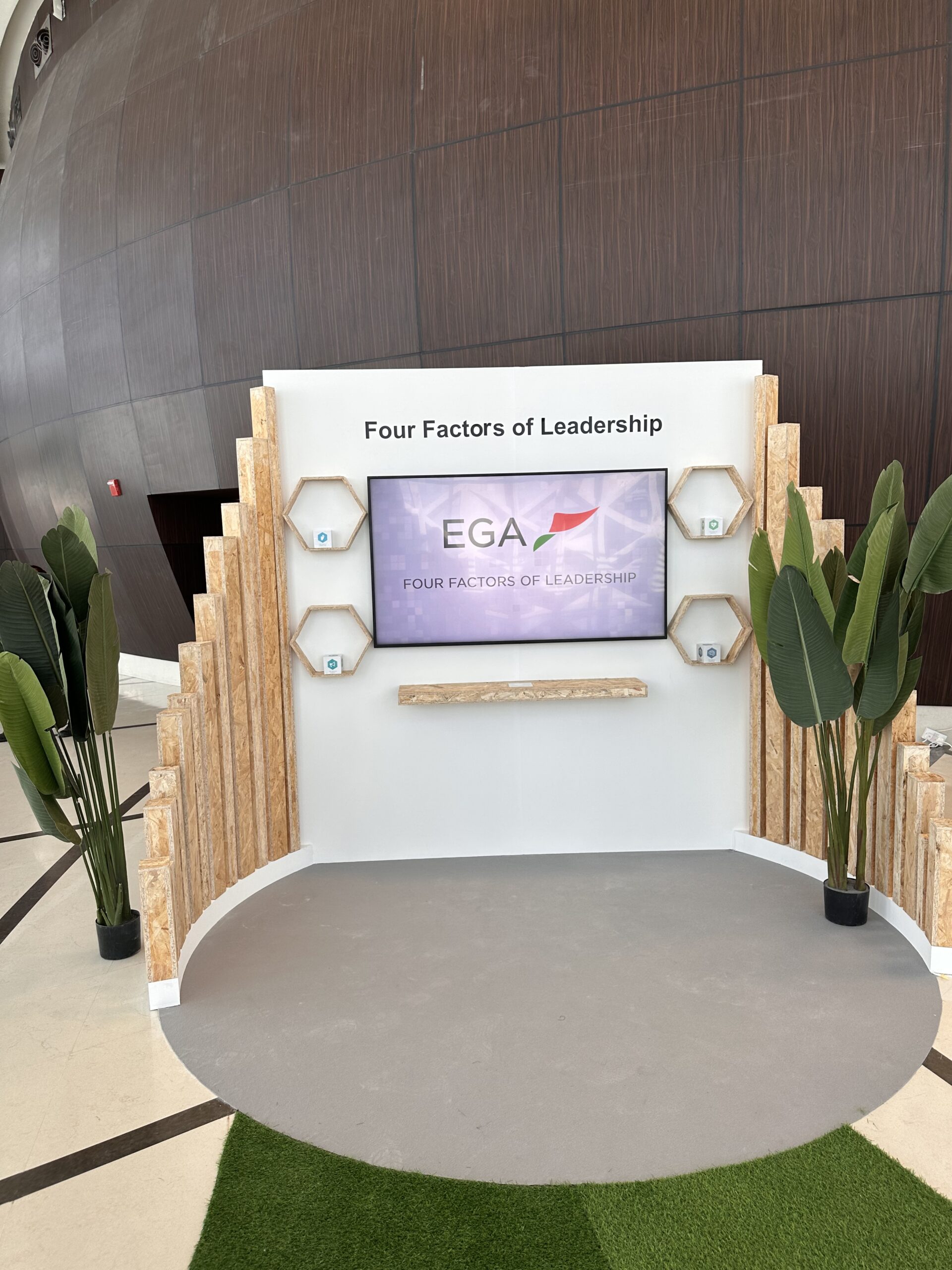 Visitor lifting a physical object to trigger digital content on an interactive display