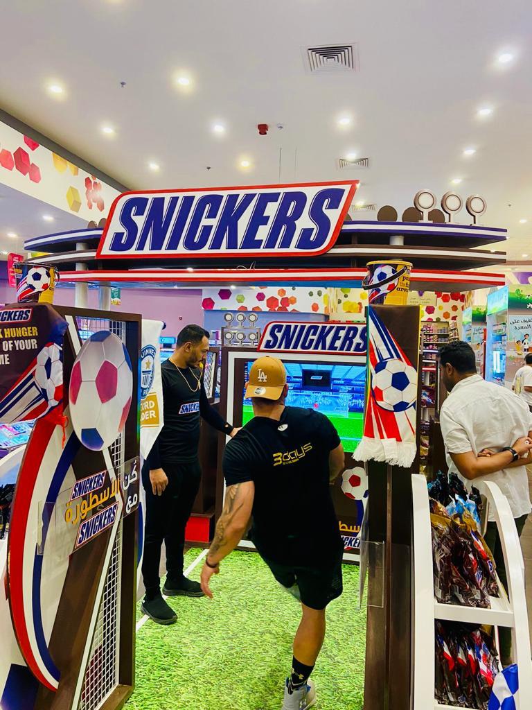 Gamified brand engagement booth featuring Snickers penalty shootout sports skill game in-store